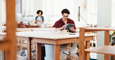 Buy stock photo Man, tablet and typing at pottery workshop with update for web store with sculpture, tea cup and review at studio. Person, digital touchscreen and manager with app for ceramic product with inventory