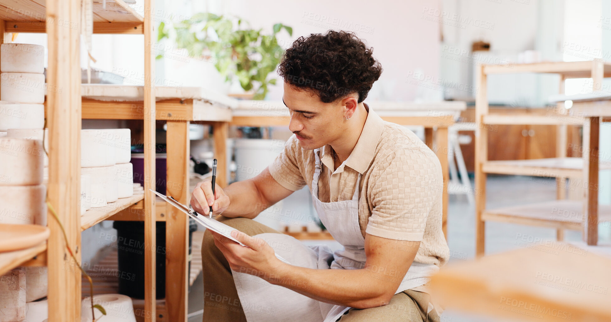 Buy stock photo Man, writing and clipboard at pottery workshop for cup inspection, review notes and stock checklist. Potter, document and quality check, inventory management and sculpture price for order information