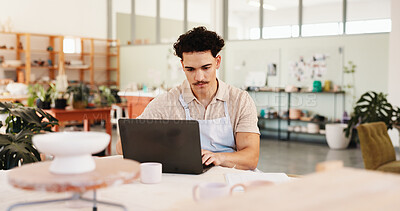 Buy stock photo Pottery, creative and man in workshop on laptop for inventory, logistics and checklist of ceramic designs. Business, art studio and person on computer for planning, online orders and store website