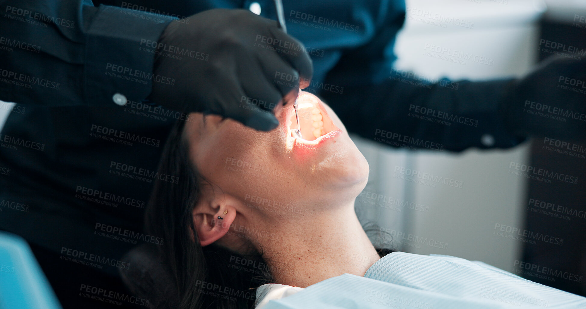Buy stock photo Hands, light and mouth of patient with dentist in office for checkup, operation or surgery. Appointment, dental hygiene or healthcare with medicine professional and woman at clinic for oral exam