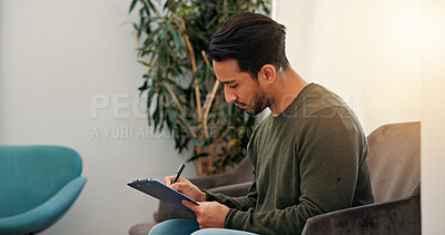 Buy stock photo Waiting room, man and writing on clipboard in clinic for personal information, insurance details or medical history. Healthcare, patient or paperwork at consultation for appointment or health checkup