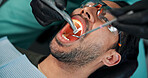 Man, patient and dentist with mouth tools for cleaning, bacteria or germ removal at orthodontist. Male person, client or teeth surgeon with drill for tooth extraction, dental or oral care at clinic