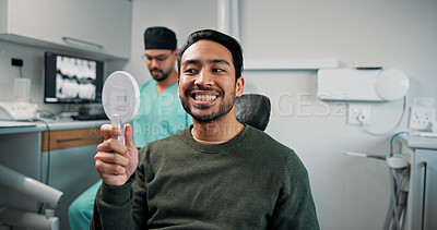 Buy stock photo Happy man, mirror and dentist with teeth for dental care, hygiene or oral treatment at orthodontist. Male person, patient or smile with surgeon for tooth removal, veneers or extraction at clinic