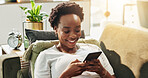 Black woman, happy and typing with phone in home for text message, dating site and social media scroll. Relax, person and internet connection on sofa for streaming service, reading ebook and research