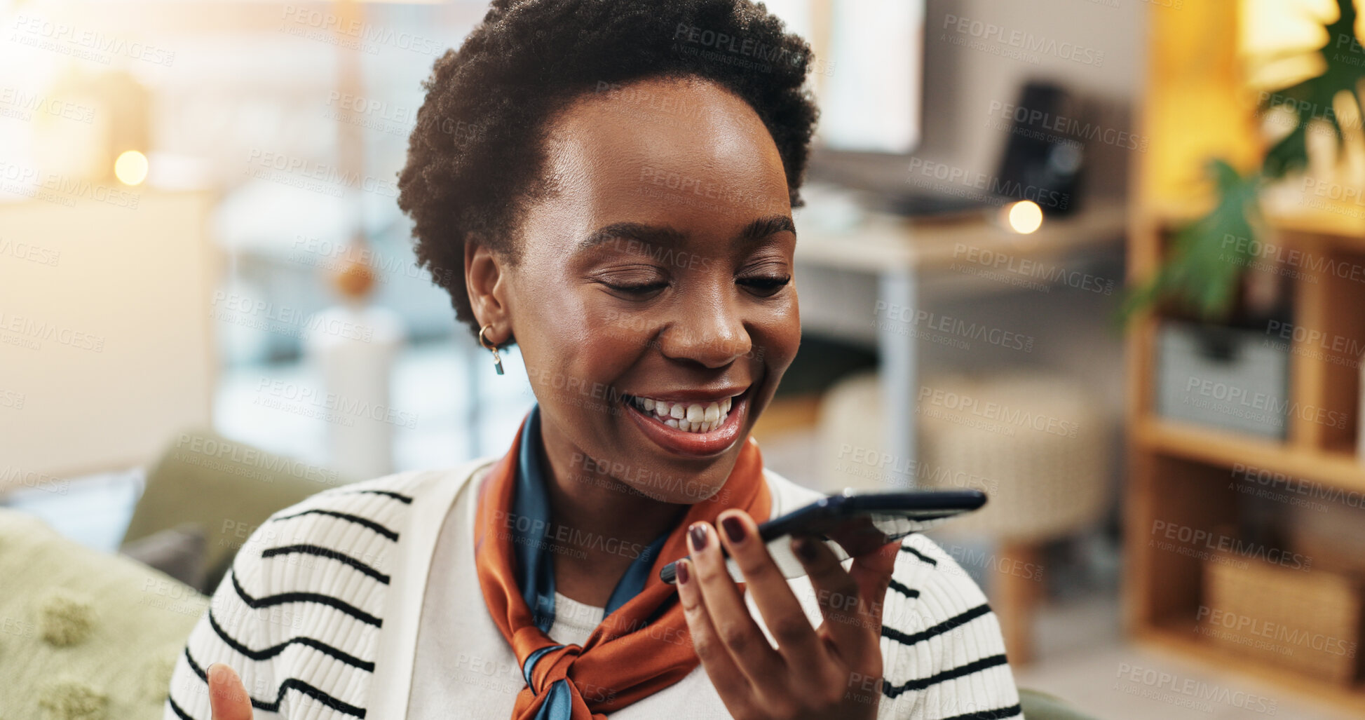 Buy stock photo Happy, black woman and talking with speaker phone on sofa for communication or audio message at home. Female person, user or smile with mobile smartphone for voice note, app or conversation at house