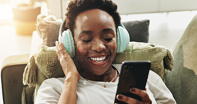 Buy stock photo Headphones, black woman and relax with phone on sofa for wellness podcast, stress relief and music playlist. Home, person and smartphone with eyes closed for calm sound, zen audio and weekend break