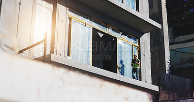 Buy stock photo Construction site, engineer and man with tablet, city and inspection in low angle, architecture and online. Building, inspector and person with tech for development, project management and renovation