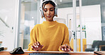 Woman, headset and typing at office with consulting, notes and report for tech support at IT startup. Person, agent and voip headphones for virtual advisory services, pc and help desk at company