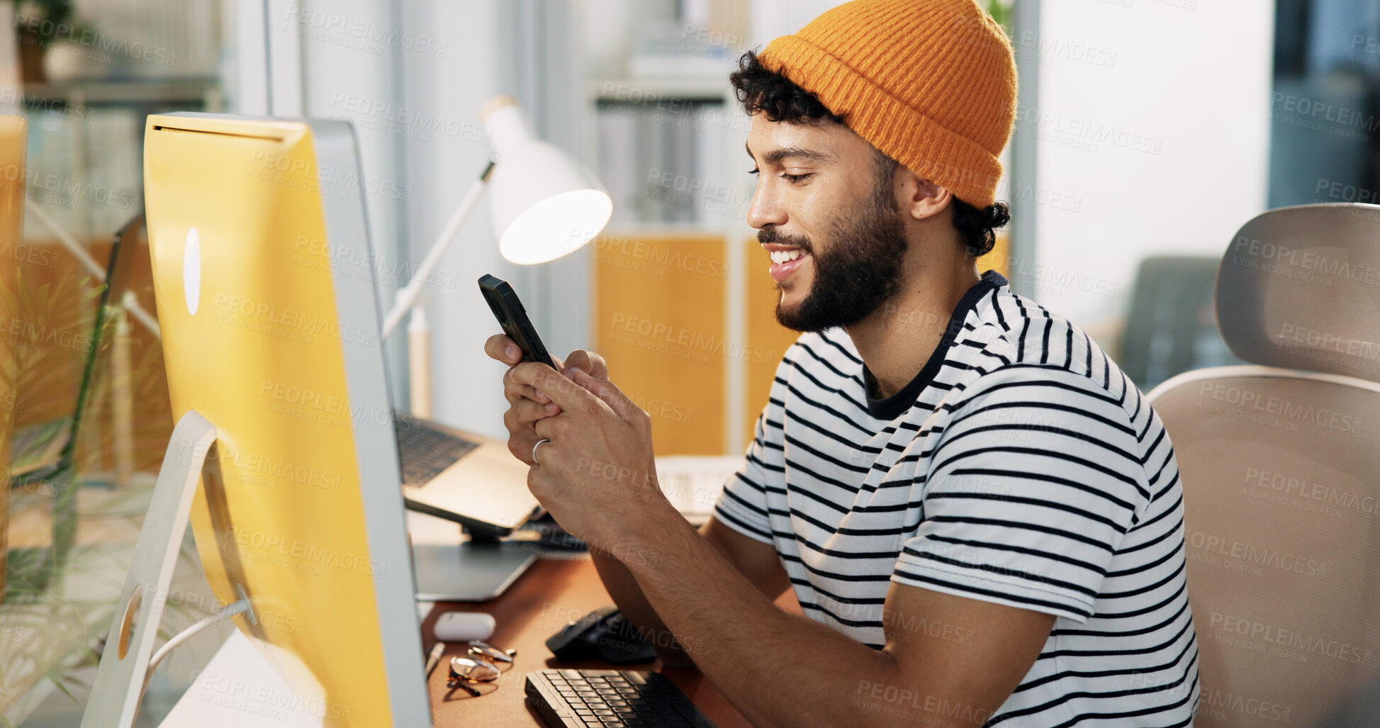 Buy stock photo Computer, web designer and man with phone in office for software, website update and user interface. Happy, digital agency and person on smartphone for social media, internet and message on break