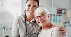 Elderly woman, physiotherapist and hug in portrait at hospital with smile, recovery or medical services. People, senior patient and embrace for wellness, happy or support in rehabilitation at clinic