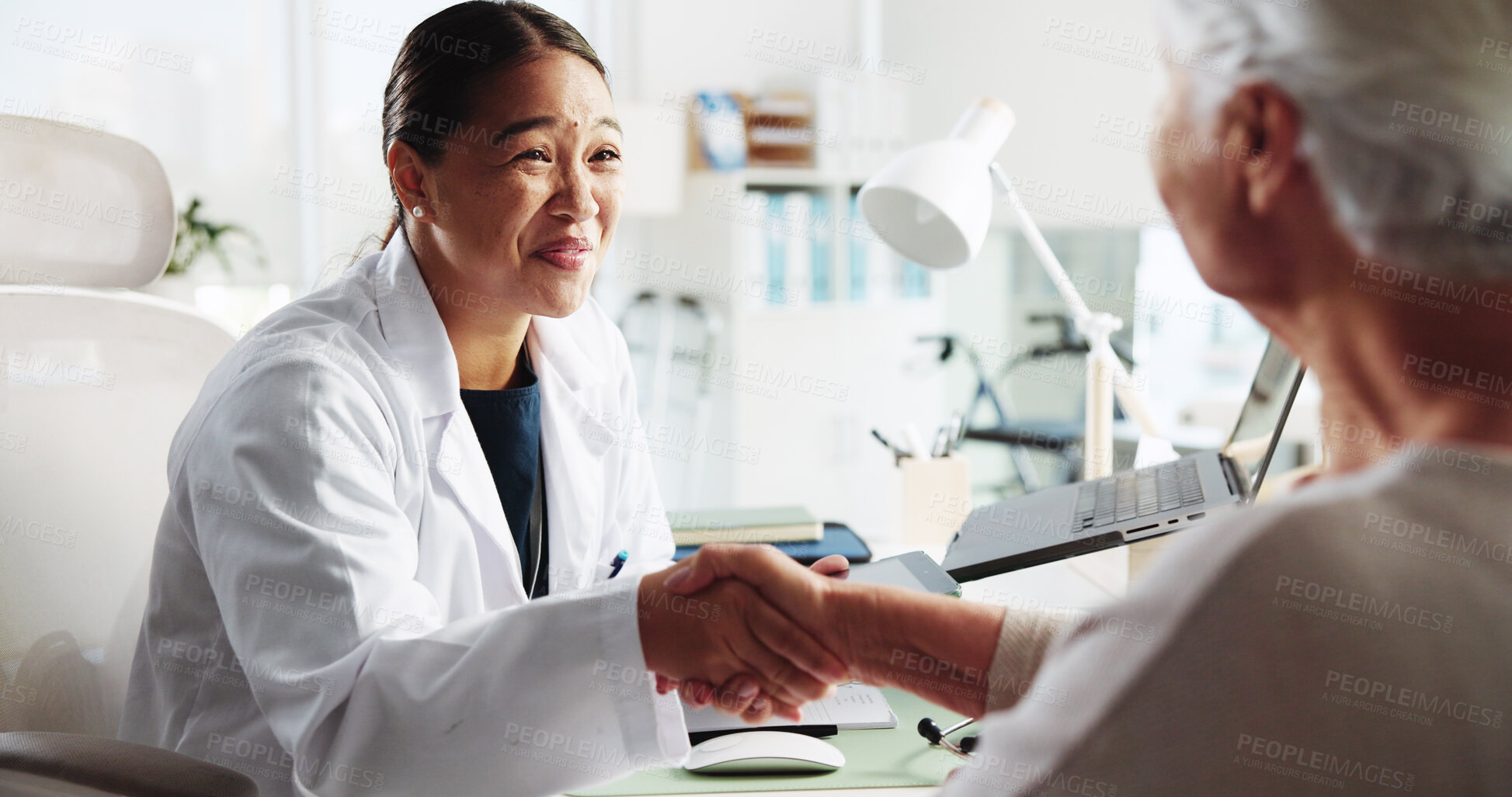 Buy stock photo Doctor, senior woman and happy with handshake at clinic for introduction, thanks or healthcare service. People, elderly patient and shaking hands for hello, smile or welcome to consulting at hospital