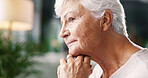 Senior woman, serious and thinking in home for nostalgia, remember memory or past decision with vision. Thoughts, elderly person and daydreaming in living room with wonder, reflection and profile