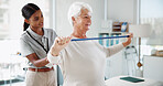 Senior woman, physiotherapist and resistance band with help, smile and healthcare services for recovery. People, happy and exercise with equipment, stretching and injury for rehabilitation at clinic