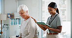 Consultation, senior patient and physiotherapist with tablet for rehabilitation, healthcare and recovery. Happy woman, physical therapy and medical support for healing back injury or help in clinic