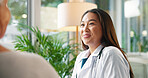 Happy woman, doctor and talking with patient for medical diagnosis, prescription or advice at hospital. Female person, healthcare worker or surgeon with client or smile for health service at clinic