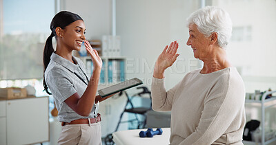 Buy stock photo Physiotherapy, happy or elderly patient with high five in clinic for recovery success, rehabilitation results or good news. Healthcare, woman and tablet with support for medical progress and healing