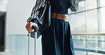 Business person, walking and hands with suitcase for travel, job opportunity or career trip at airport. Closeup, employee or traveler with luggage for commute, flight or journey in city or town