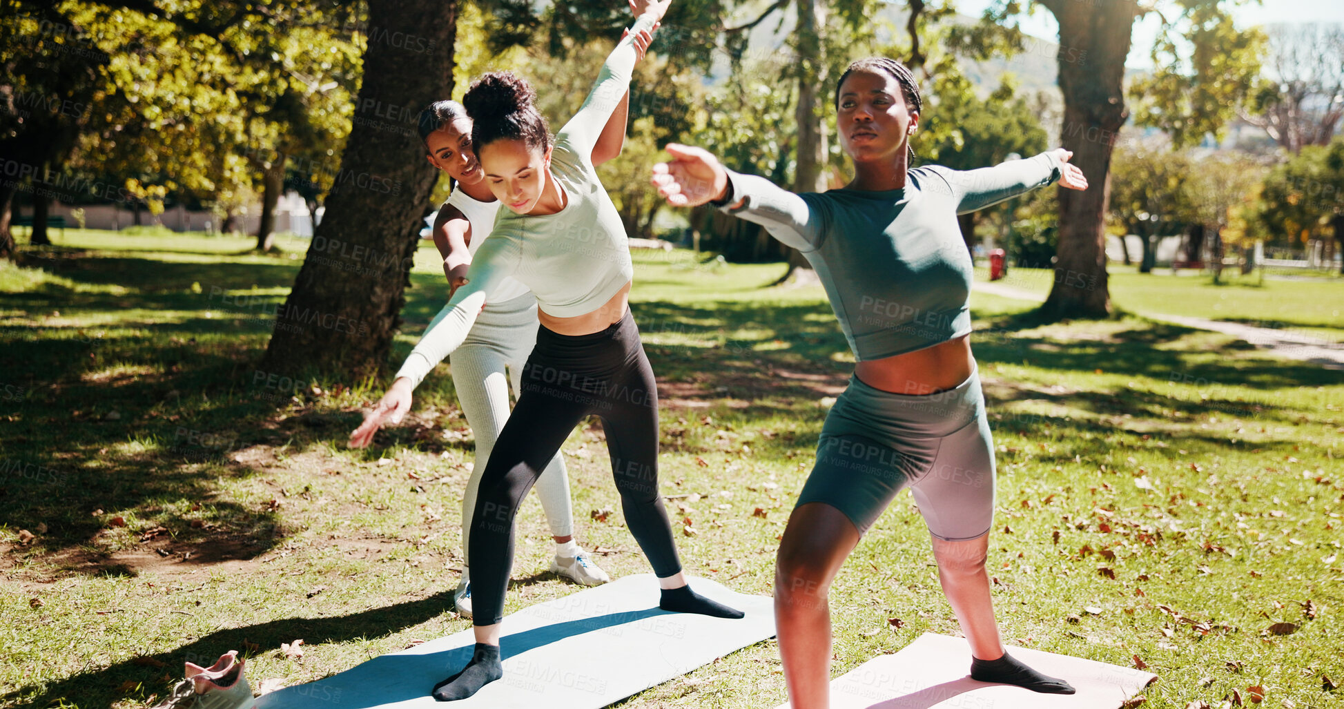 Buy stock photo Nature, instructor and women with stretching for yoga, wellness and chakra with support for balance. Outdoor, people and coach with helping for warrior pose, arms exercise and fitness for yogi group