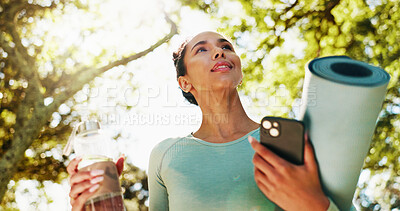 Buy stock photo Fitness, woman and happy with yoga mat at park for wellness exercise, water bottle and ready for pilates. Below, yogi and phone with equipment in nature for health routine, start workout or fresh air