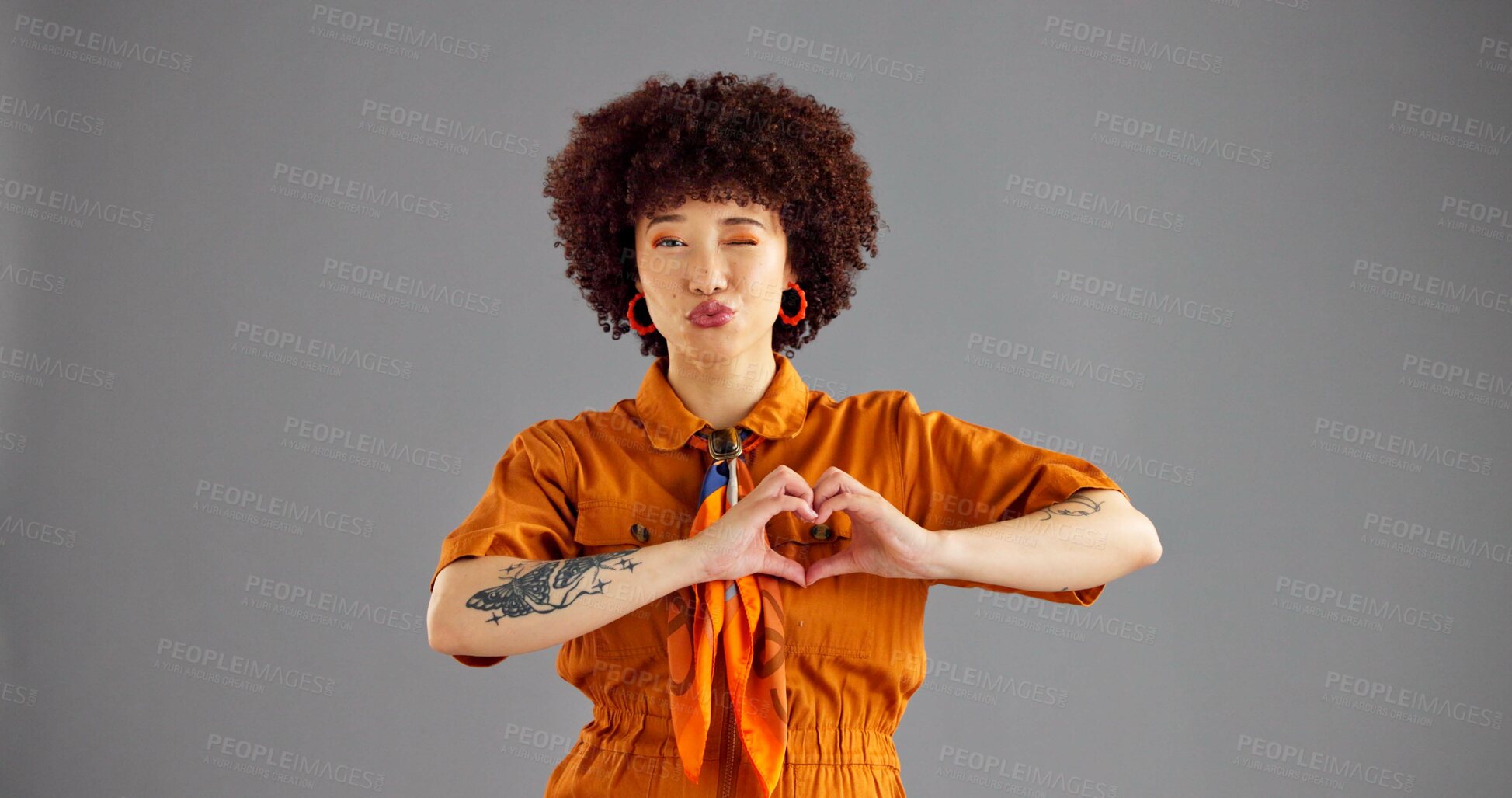 Buy stock photo Fashion, portrait and woman with heart shape, studio and confident with stylish outfit, mockup and love. Gray background, proud and person with gesture for care, space and girl with emoji in USA