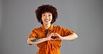 Fashion, smile and woman with heart shape, studio and confident with stylish outfit, mockup and love. Gray background, portrait and person with gesture for care, space and girl with emoji in USA