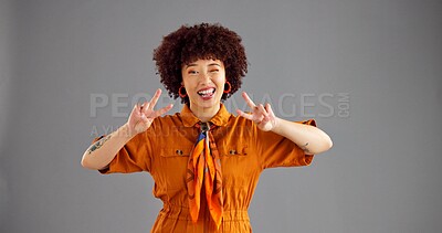 Buy stock photo Portrait, peace sign and woman wink with funny face for retro fashion isolated on gray studio background space. Happy person, hand gesture and v symbol for victory, goofy and silly with tongue out