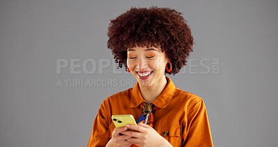 Buy stock photo Studio, fashion and woman with smartphone, texting and browsing on social media, mockup space and online. Gray background, typing and person with mobile for message, communication and smile for chat