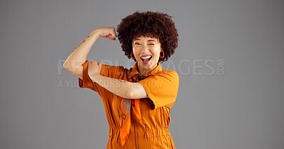 Buy stock photo Portrait, flexing arms and woman with wink, win or power with confident personality on grey studio background. Smile, happy person or victory with gesture, space or female empowerment with challenge