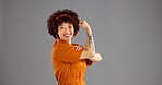 Portrait, flexing arms and woman with victory, power or win with confident personality on grey background. Face, happy person or model with space, challenge or female empowerment with smile or strong