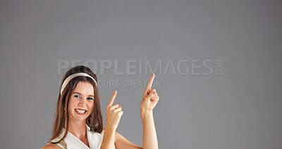 Buy stock photo Portrait, happy woman and pointing up in studio for marketing, mockup or discount deal. Smile, advertising and person with presentation on space for sales, promo and special offer on gray background