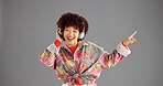 Headphones, smile and woman in studio, listening to music and singing on grey background. Person, mockup space or happy model with confidence, fashion and headset with audio, streaming radio or sound