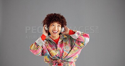 Buy stock photo Headphones, smile or woman in studio, fashion or vintage clothes on grey background. Person, space or happy model with radio, retro outfit or headset with audio, streaming song or decision with sound