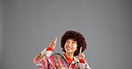 Smile, woman and pointing up for advertising, mockup info and discount news. African person, marketing and show space for retro fashion, sales promotion and coming soon on gray studio background