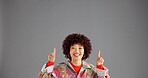 Portrait, happy woman and pointing up for advertising, mockup info and discount deal. African person, marketing and show space for retro fashion, sales promotion and offer. on gray studio background