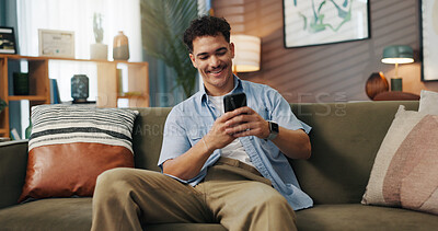 Buy stock photo Texting, smile and man with phone in home for communication, chat and reading message. Sofa, relax and happy person with mobile for social media, online dating and browsing website to download app
