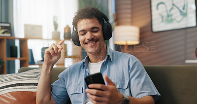 Buy stock photo Phone, man and dancing with headphones on sofa for audio subscription, music playlist and weekend break. Relax, person and happy with internet connection in home for radio app, podcast or sound track