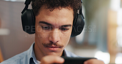 Buy stock photo Playing, video games and man with headphones, smartphone and serious for virtual sport in apartment. Online, gamer and person with mobile app for entertainment, streaming or player with tech in house