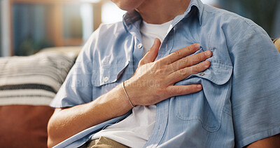 Buy stock photo Hand, chest pain and man in home for health, panic attack or pressure for cardiovascular medical issue on sofa. Indigestion, heartburn or male person with respiratory illness for emergency at house