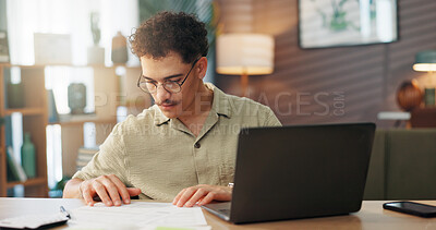 Buy stock photo Man, laptop and documents in home for budget, personal finances and monthly expenses for startup. Entrepreneur, tech and paperwork in lounge for small business management, invoice payment or taxes