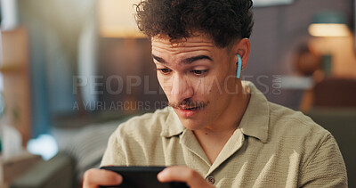 Buy stock photo Man, smartphone and shock with earphones for gaming in home, streaming and happy surprise with esport. Gamer, wow and person in house with mobile app for videogame, wireless audio tech and tournament