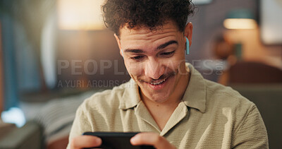 Buy stock photo Smile, gaming and man with smartphone, home and listening to sound with earphones, streaming and online. House, gamer and person with mobile app for entertainment, happy and player with tech for fun