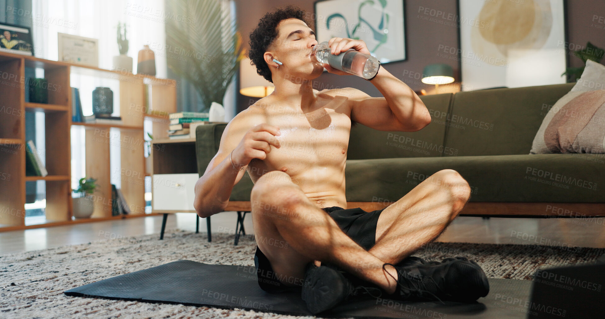 Buy stock photo Home, drinking water and man in lounge, fitness and relax with hydration, wellness and break. Apartment, shirtless and healthy person with liquid, thirsty and exercise with workout, tired and fatigue