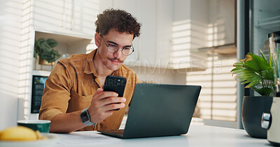 Buy stock photo Home, cellphone and man in kitchen, laptop and online reading with creativity, project research and review. Social media, freelancer or person with pc, smartphone or feedback for proposal or chatting
