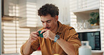 Coffee, calm and man in kitchen in home with peaceful, relax and comfort with morning routine. Fatigue, mug and tired male person drinking tea, caffeine latte or cappuccino in apartment for beverage.