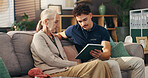 Old woman, nurse and tablet on couch, sad and report with diagnosis in living room in home. Caregiver, elderly person and digital touchscreen for health, app and results with bad news in retirement