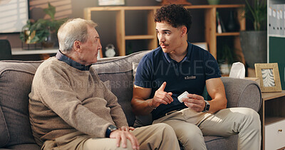 Buy stock photo Caregiver, senior man and pills on sofa with medication instructions, tablets information and illness management. Homecare, patient and healthcare worker with prescription drugs for health treatment