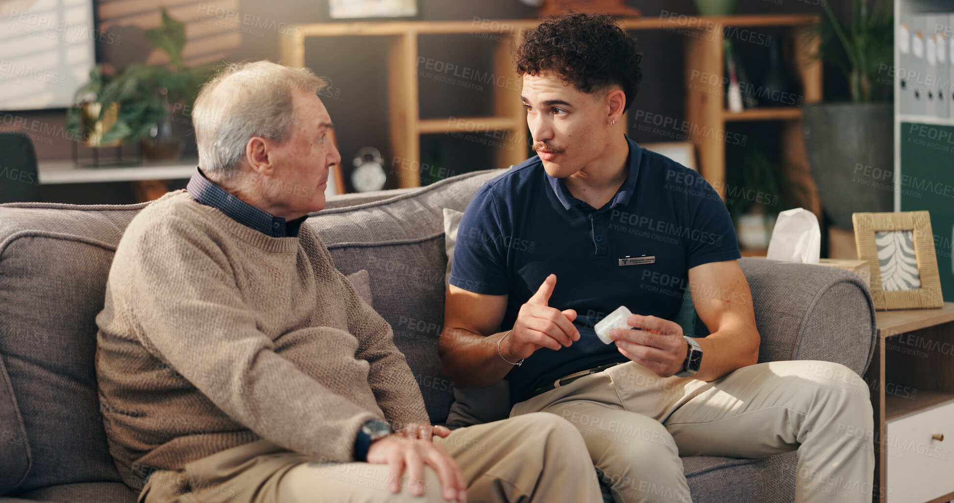 Buy stock photo Caregiver, senior man and pills on sofa with medication instructions, tablets information and illness management. Homecare, patient and healthcare worker with prescription drugs for health treatment