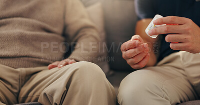 Buy stock photo Hands, patient and caregiver with pills on sofa for illness management, prescription drugs and explain dosage. Medicine, person and healthcare worker with medication discussion for health treatment