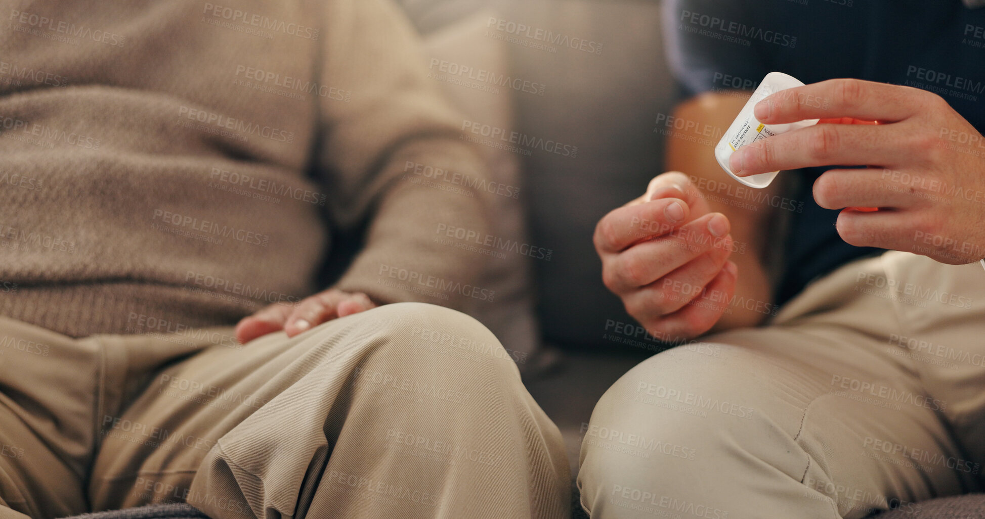 Buy stock photo Hands, patient and caregiver with pills on sofa for illness management, prescription drugs and explain dosage. Medicine, person and healthcare worker with medication discussion for health treatment