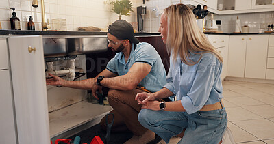 Buy stock photo Plumber, man and woman by kitchen sink for pipe, inspection and check for leak for maintenance at house. People, handyman and client with assessment, repair and problem solving for drain at apartment